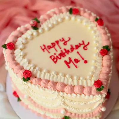 A classic heart-shaped cake for a mother's birthday. This design features vintage-style Lambeth piping in pink and white, with tiny piped red roses for a loving touch.