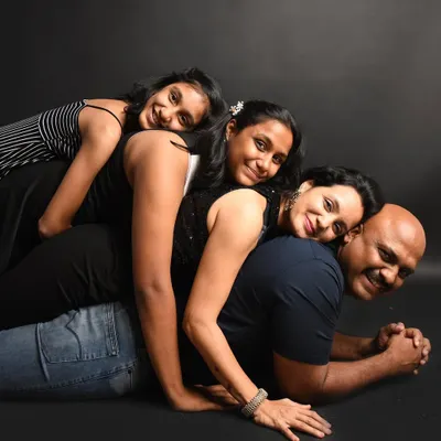 A family is a little bit of crazy and a whole lot of love! This fun pose shows the playful and loving connection between everyone. I love creating dynamic family portraits that show your family's true personality.