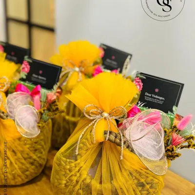 Wrapped in a burst of marigold yellow, these festive hampers are an ode to joy. The woven basket and delicate floral accents make them perfect for adding a touch of luxury and colour to any celebration, from Diwali to a wedding.