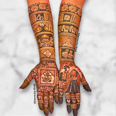 This full bridal design is a perfect example of storytelling, with a detailed couple portrait on one palm and a Ganesha figure on the other for blessings. The arms are filled with traditional wedding symbols like dhol, shehnai, and elephants.