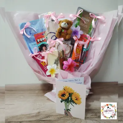 A gift bouquet I designed for actress Helly Shah in a pink theme. Instead of flowers, this bouquet is filled with small gifts like skincare items, a teddy bear, and protein bars.