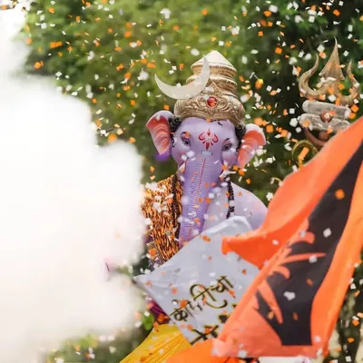 A dynamic shot of Kopri Cha Samrat, using smoke and confetti to create a festive and energetic atmosphere during the procession.