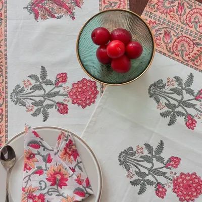 I believe every meal can be a special occasion. This complete table linen set, featuring a runner, placemats, and napkins in a soft peach floral design, adds a touch of handcrafted elegance to your dining table.