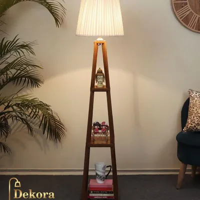 This dark wood finish shelf lamp offers a sophisticated alternative for your living space. The integrated shelves are perfect for displaying small plants or decor, while the pleated shade casts a soft, inviting glow.