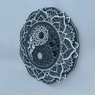 An angled view of our Yin Yang mandala, highlighting the distinct 3D layers that give the piece its sculptural quality. The contrast between black and white is crisp and defined.