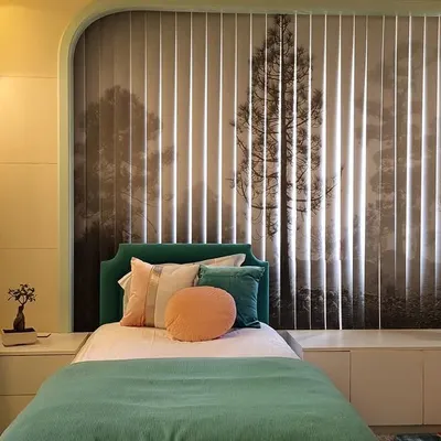 We designed this room for two young girls, inspired by fairytales and novels. The custom-printed vertical blinds come together to form a magical forest scene, creating a backdrop that sparks creativity and imagination. The teal and peach color scheme keeps the space feeling fresh and youthful.