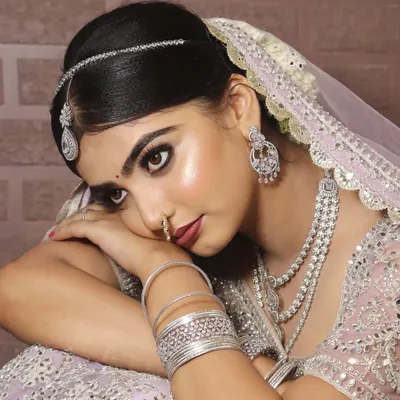 Soft bridal glam at its finest. This beautiful pastel lehenga is paired with a dewy, luminous makeup look, featuring a subtle smokey eye and a soft pink lip for a modern and romantic feel.