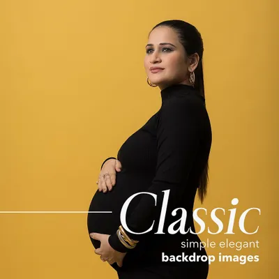 A classic, elegant maternity portrait against a bold yellow backdrop. This style is perfect for creating a timeless and striking image that focuses on the beauty of your silhouette.