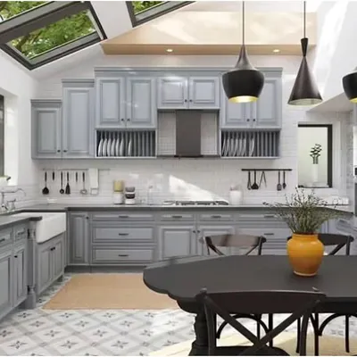 This stunning U-shaped kitchen features classic shaker-style cabinets in a soft grey, beautifully illuminated by skylights. The layout includes an eat-in dining area, making it a perfect family hub.