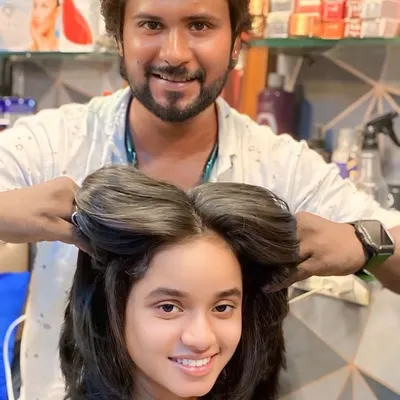 Here I am adding the final touches to a voluminous, layered haircut. You can see how the layers create a full, bouncy shape, even before the final styling.
