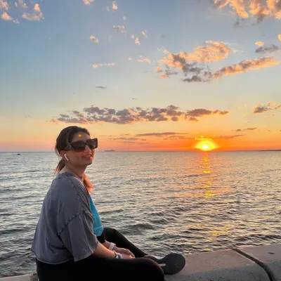 Enjoying a magical sunset over the ocean. There is something so calming about watching the sun dip below the horizon, and it's a perfect time for quiet reflection.