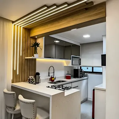 This compact kitchen is enhanced with a stylish breakfast bar, featuring dramatic integrated LED lighting. It's a perfect example of how to add functionality and flair to a smaller space.
