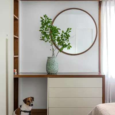 A custom dresser and vanity from our 'Pepper and Coffee' project, featuring a round mirror and integrated shelving.