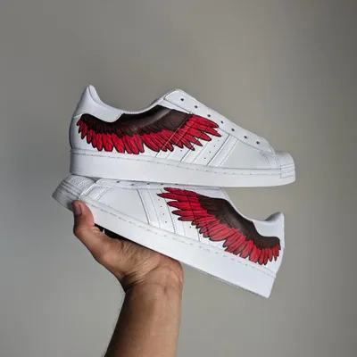 A pair of Adidas Superstars with fiery red wings that I painted live at an Adidas event in Bengaluru.