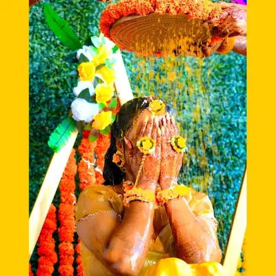 A classic Haldi moment, as the bride is showered with turmeric and flower petals. I capture the joy and tradition of this beautiful pre-wedding ritual.