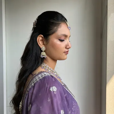 This soft glam look is perfect for a bridesmaid or sister of the bride. The clean, radiant base and pop of purple on the eyes create a fresh and youthful appearance.