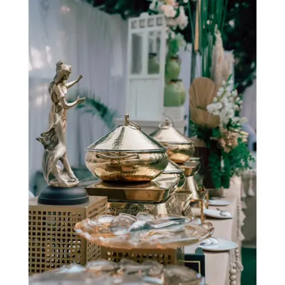 It's the little things that make a big difference. An elegant statue and golden serving dishes add a touch of class and artistry to the buffet display.