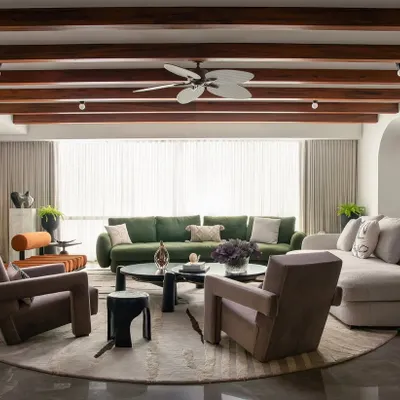 In this Parisian-inspired home in Trump Towers, the design is carefully curated to deliver a certain quality of life. The white-hued space is grounded by earthy tones, exposed wooden beams, and eclectic furniture, creating an atmosphere that is both sophisticated and joyful.