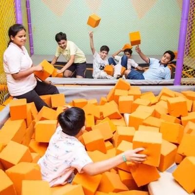 The energy is always high in our foam pit! It's part of our large, safe play zone where kids can jump, tumble, and play to their heart's content.