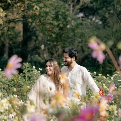 A dreamy portrait of a couple in a field of wildflowers. I use the flowers in the foreground to create a soft, romantic frame, making the scene feel like a painting.