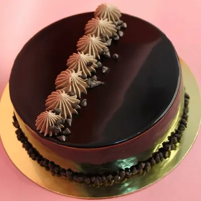 Our number one bestseller, the classic chocolate truffle cake. With a glossy mirror glaze and rich, moist sponge, this cake is pure, simple, and utterly delicious.