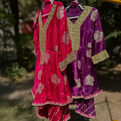 Here are two of my most popular Gota Patti sharara sets, hanging side-by-side. You can see the rich velvet fabric and the intricate gold embroidery that makes these outfits so luxurious and perfect for weddings.