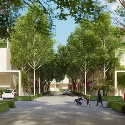 At Aranya Villas, the streets are designed for people, not just cars. This view shows a family enjoying the pedestrian-friendly environment, where lush greenery, wide pathways, and minimal architecture create a safe and serene residential community.
