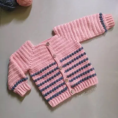 This is the Dewdrops Cardigan, a cozy and stylish piece for winter. The design features textured bobble stitch stripes and simple wooden buttons, making it a timeless handmade sweater.