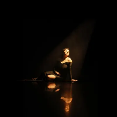 A dramatic spotlight portrait. This artistic, high-contrast style creates a powerful and timeless image that focuses entirely on you and your journey.