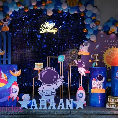 A complete space-themed birthday party setup. We designed a galaxy backdrop with a balloon arch, planet cutouts, and a personalized name sign for the birthday boy, Ahaan.