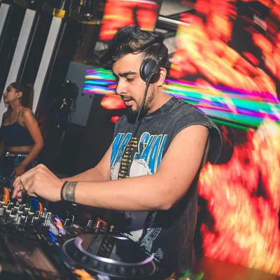 Deep in concentration, surrounded by fiery visuals. This is me in the 'kitchen', cooking up a set with layers of Bollytech, Trap, and Dubstep.