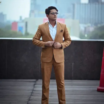A classic full-length pose for a corporate lookbook. The model is adjusting his suit jacket, which gives the photo a natural, in-the-moment feel while still looking professional and sharp.