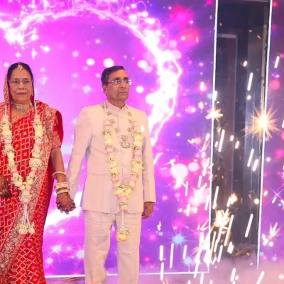 The anniversary couple makes a grand entrance with sparklers and smoke, creating a magical and cinematic moment.