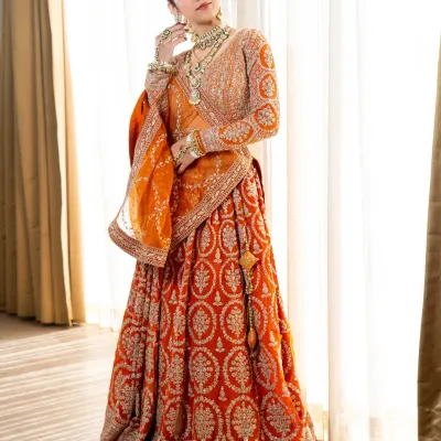 This stunning burnt orange and red lehenga is perfect for the bride who wants a traditional yet vibrant look. The intricate sequin and thread work is absolutely breathtaking.