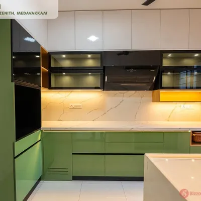 A complete view of the pastel green parallel kitchen at Casagrand Zenith. This design features high-gloss handleless cabinets, a white quartz countertop that extends to the dado, and black tinted glass overhead units for a striking contrast.
