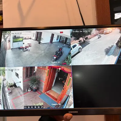 A multi camera view for a bungalow, showing the front gate, main door, and parking area. This setup ensures all entry points are monitored.