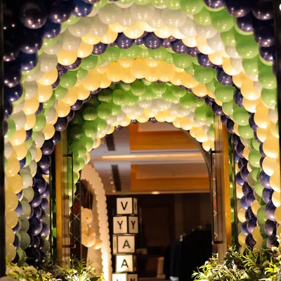The entrance to "The Polo Club" birthday, featuring a grand balloon arch in classic navy, green, and yellow, setting a sophisticated tone.