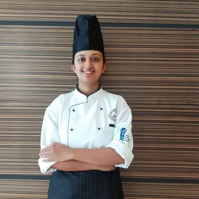 A portrait of me in my chef's uniform. This represents the professional dedication I bring to my passion for authentic Indian cooking.