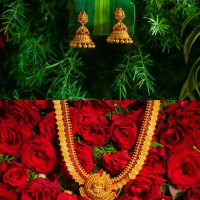 A creative product shot of traditional gold temple jewelry, beautifully arranged on a bed of red roses to evoke a sense of romance and luxury.