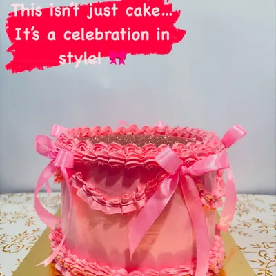 This is my signature Pink Bow Cake, a true celebration in style. It features hand-piped buttercream ruffles and is tied with beautiful satin ribbons, with a sparkling top for extra glamour.