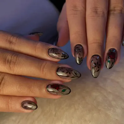 A full view of our stained-glass rose nail art. This design features intricate, hand-painted roses on a sheer, glossy base, creating a beautiful and dramatic effect across all ten nails.