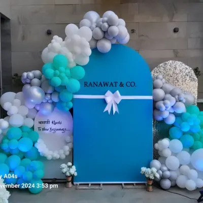 This branded arch for Ranawat & Co. uses their signature blue color, framed by a stylish balloon arrangement in teal, white, and grey. It's a great way to welcome guests to a new office opening or brand launch.