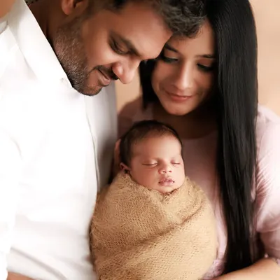 A perfect, peaceful moment for new parents adoring their swaddled newborn. These studio sessions are designed to be calm and intimate, focusing on the blessing of your new arrival.