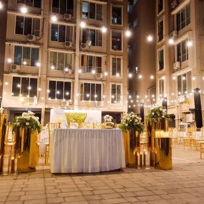 We had the absolute joy of planning this elegant 70th birthday celebration in a building compound. We used golden pedestals, soft florals, and a canopy of string lights to create a graceful and festive atmosphere that reflected the family's spirit.