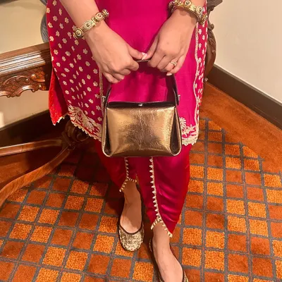 All your festive looks are sorted with my Mini Pochette bag and hand-embroidered Juttis from the Nazrana collection. This pairing is all about celebrating Indian craftsmanship with a touch of modern luxury.