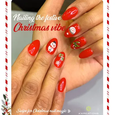 Get into the Christmas spirit with this cheerful bright red manicure, featuring adorable hand-painted snowmen and mistletoe accent nails.