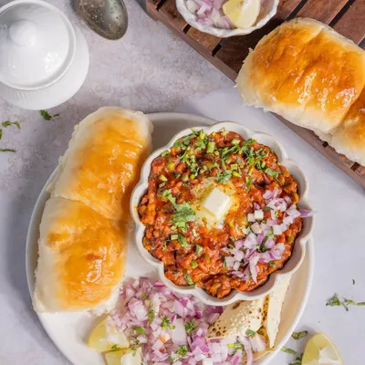 A classic Mumbai Pav Bhaji, served with extra onions and a dollop of butter that makes you want to dig right in.