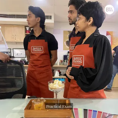 Students during their practical exam, putting their beverage creation and presentation skills to the test. Our flagship program culminates in assessments that mirror real-world cafe scenarios.
