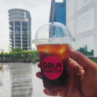 A real-life shot of my Iced Americano, perfect for a hot Noida day. This shows a customer enjoying a refreshing cold coffee against the backdrop of the city.