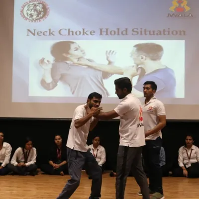 Demonstrating a defense against a neck choke hold during a workshop for over 250 female students at GL Bajaj Institute. Practical skills for real-world safety.